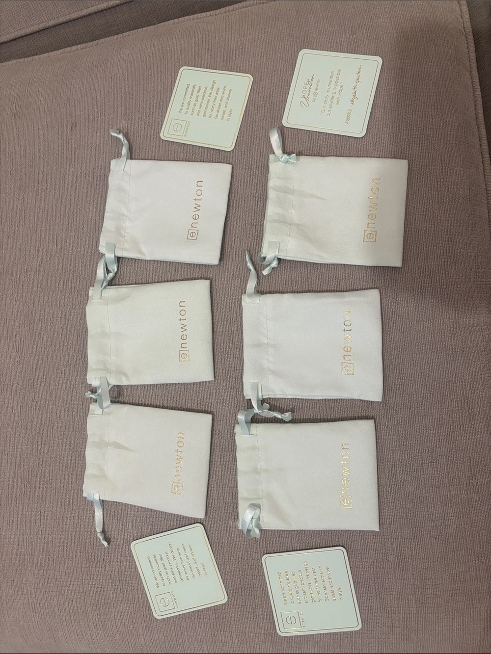 Newton Cream Satin Drawstring Pouches with Gold Logo (Set of 6, but can buy 1)